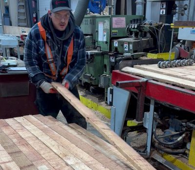 Moulder operator loading wood into WEINIG Moulder