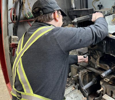 Worker making adjustments to Leadermac